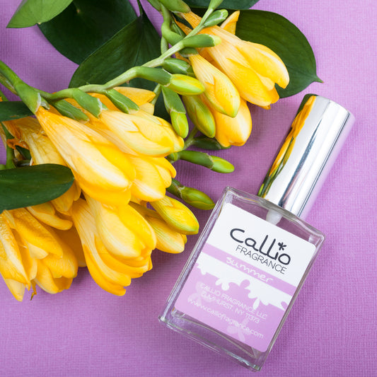 Summer one-ounce bottle on a purple background with freesia flowers.