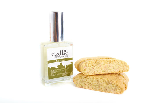 Tessa Perfume on white background with two biscotti cookies.