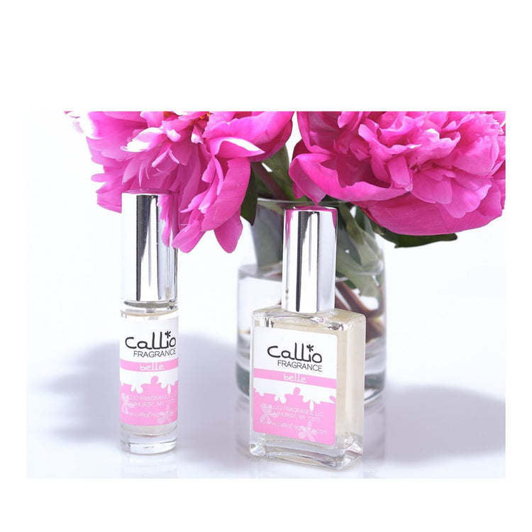 Image of Belle 1 oz and Travel-Size perfumes by Callio Fragrance on a white background with two peonies in a glass vase.