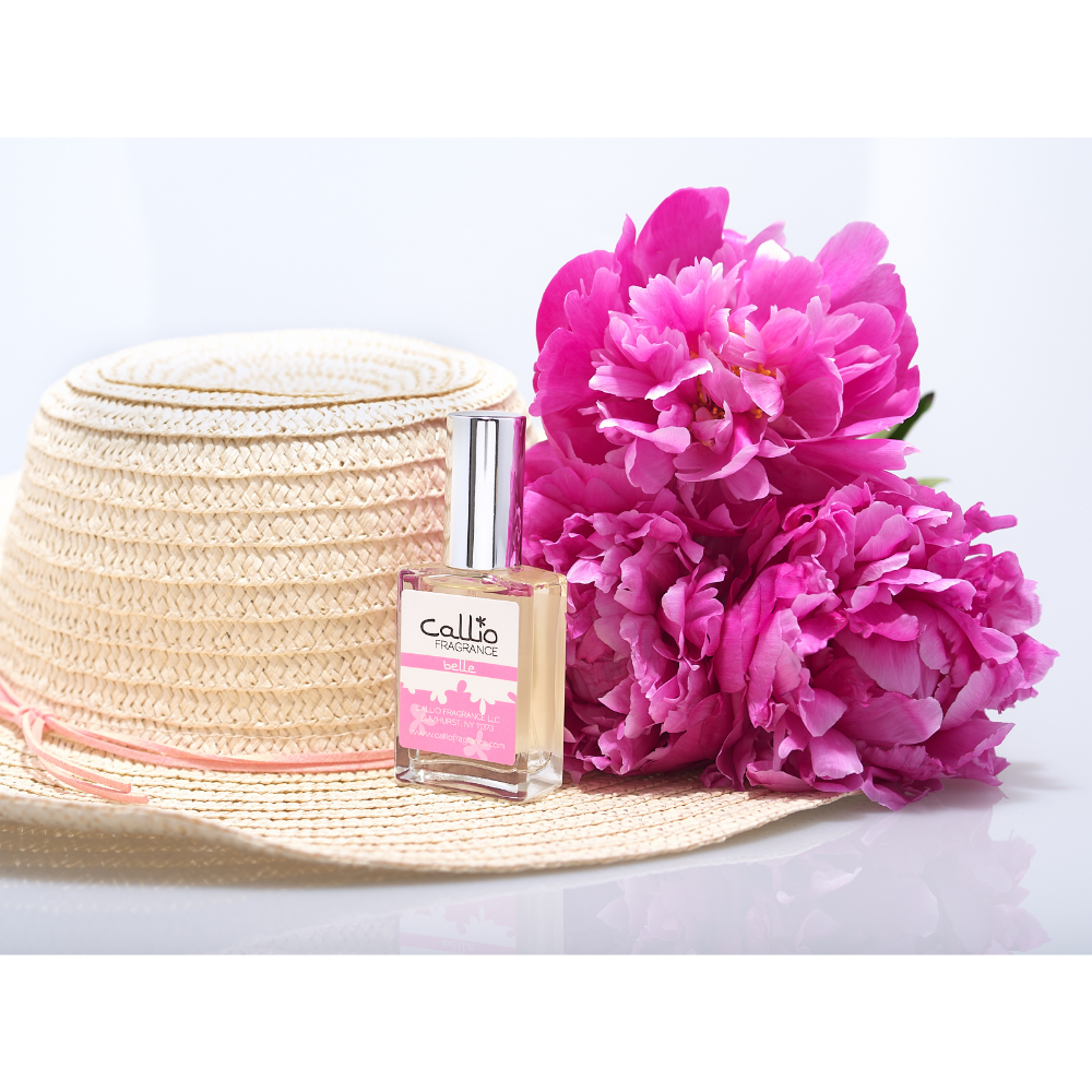 Belle one-ounce perfume with pink peonies and a straw hat.