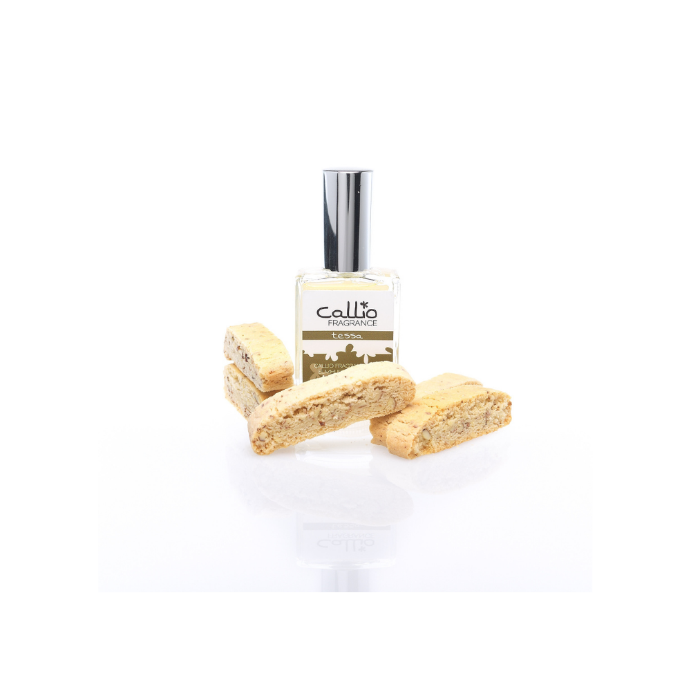 One ounce Tessa Spray Perfume surrounded by 5 almond biscotti cookies on a white background.